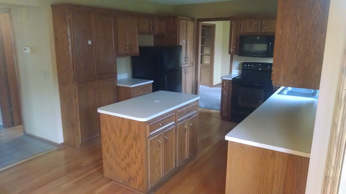 Original oak kitchen and dated layout before the remodel