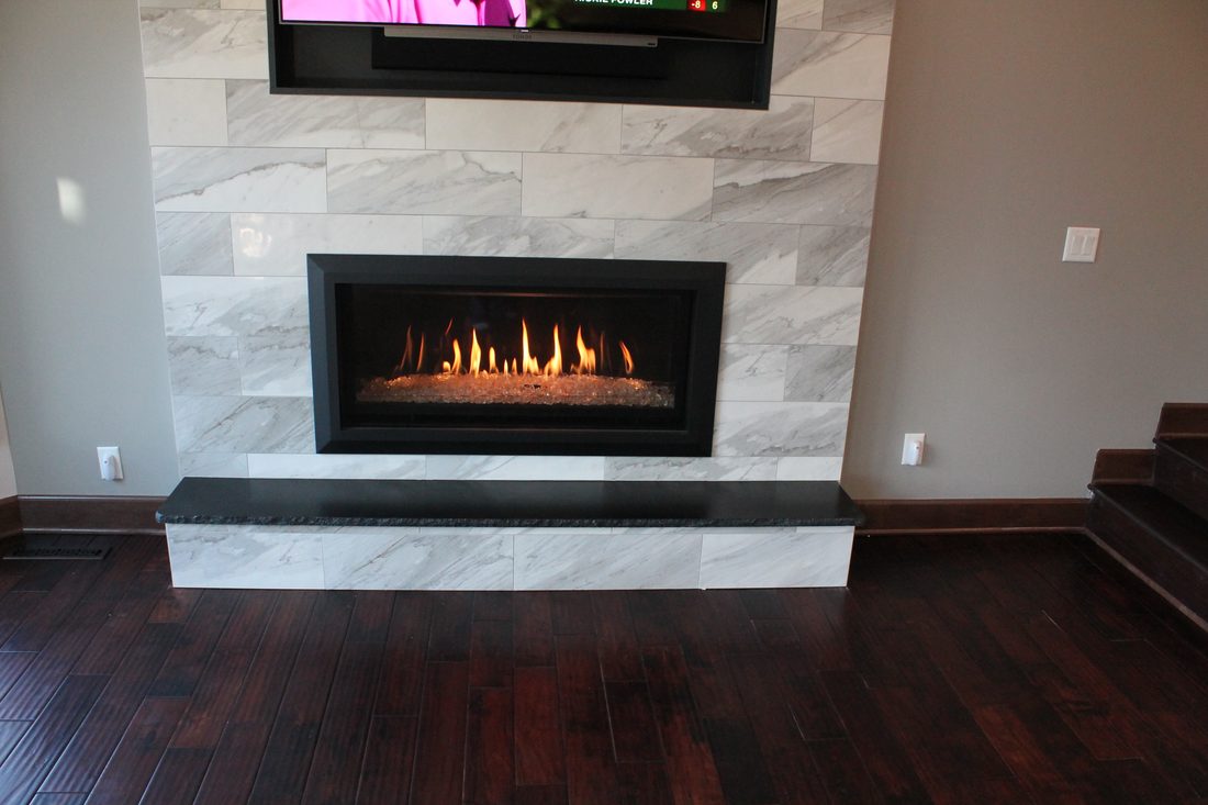 Linear gas fireplace with a marble-look surround